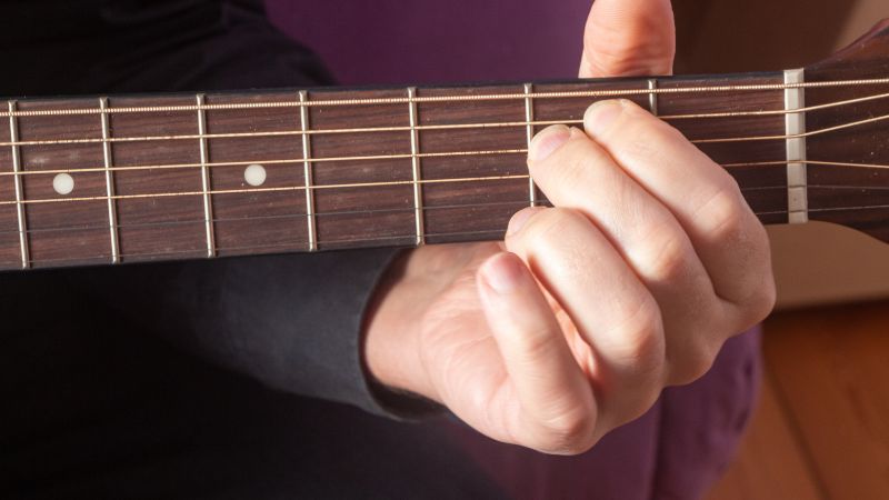 Playing guitar with fat fingers